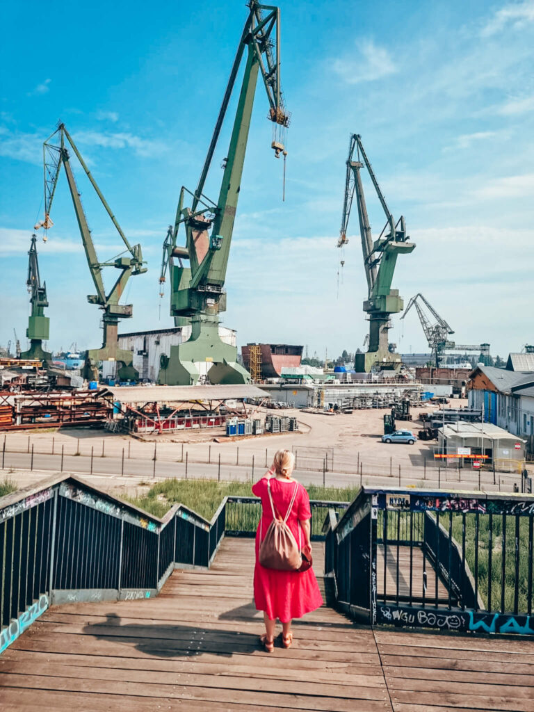 Aleksandra looking at cranes in Gdańsk shipyard