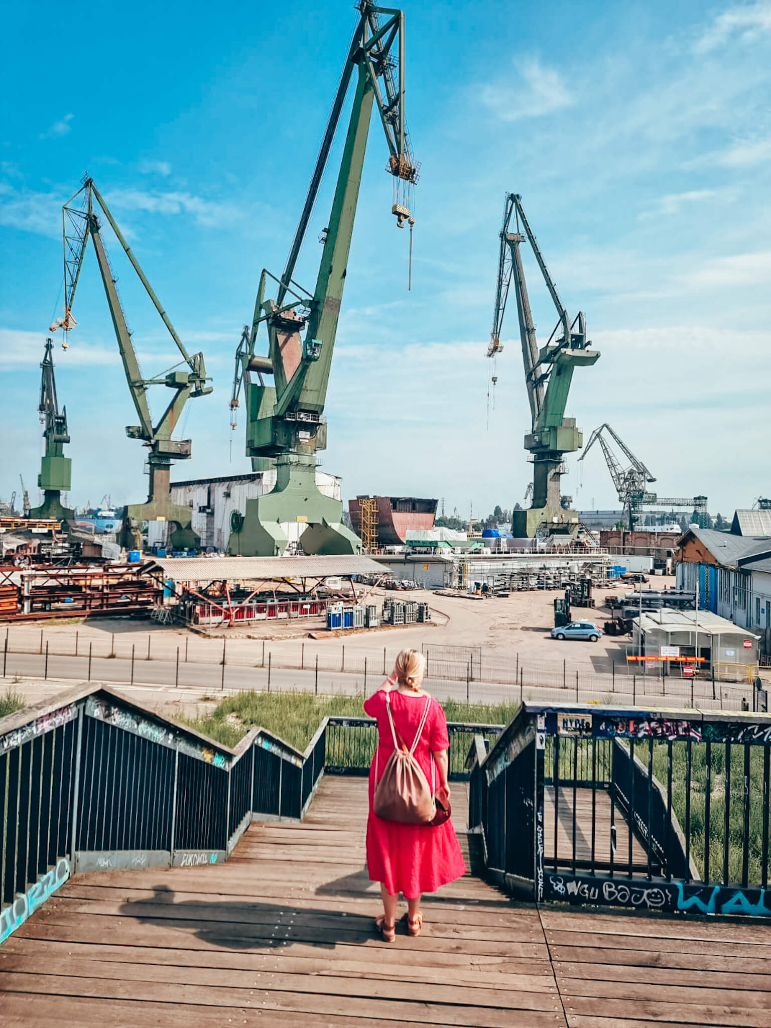 Aleksandra looking at cranes in Gdańsk shipyard