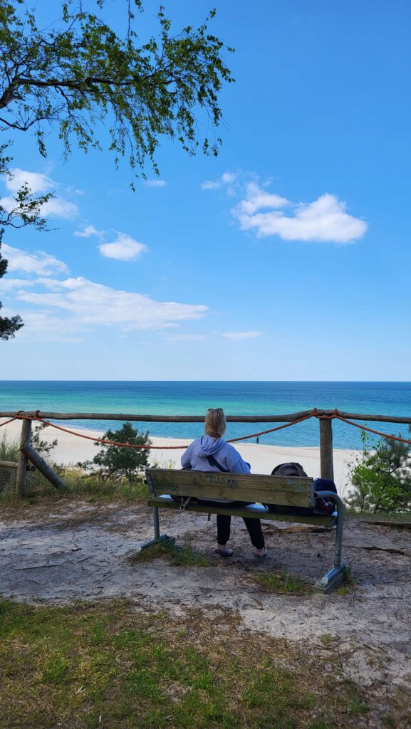 Aleksandra sitting at bench at Mountain Libek and looking at the sea