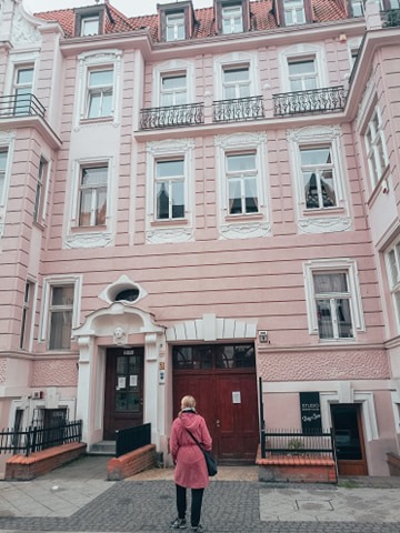 Aleksandra looking at the pink tenement
