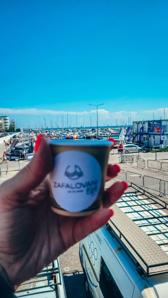 paper cup with coffee drinken in cafe in marina in Gdynia