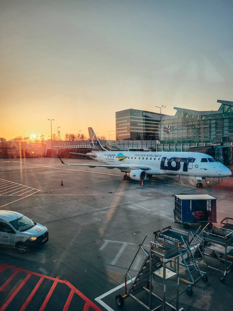 LOT plane standing at the Warsaw airport in sunrise colours